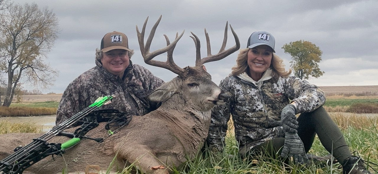 HEATWAVE hunter field photo with whitetail buck during deer season.